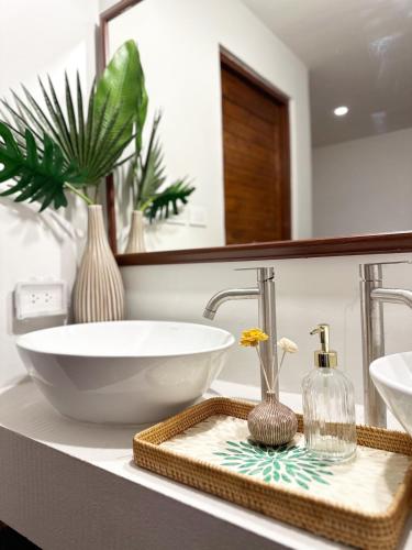a bathroom with a bowl sink and a mirror at Bunya House near BTS Asok, Terminal21 Free BF in Bangkok
