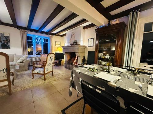 uma sala de estar com uma mesa e uma lareira em Maison lumineuse 2mn plage et village de Morgat em Crozon