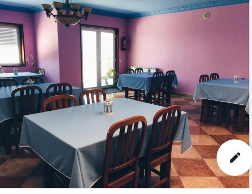 a restaurant with blue tables and chairs and purple walls at Estalagem Bela Vista in Mondim de Basto