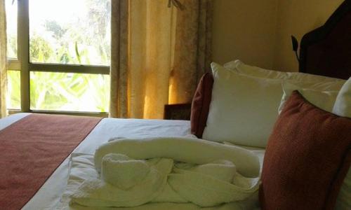 Ένα ή περισσότερα κρεβάτια σε δωμάτιο στο Okavango Roadside Guesthouse