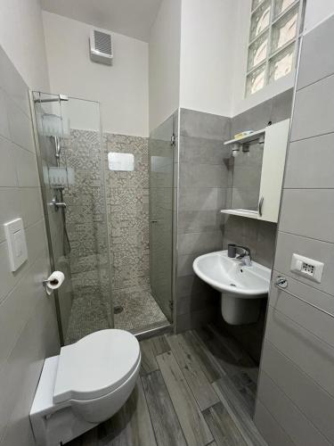 a bathroom with a shower and a toilet and a sink at La casa di pinocchio in Bacoli