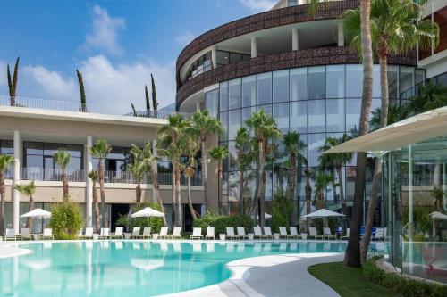 an exterior view of a building with a swimming pool at Mara's Apartments Higuerón West - Mediterranean Style - Beach & Golf - Large Sunny Terrace in Fuengirola