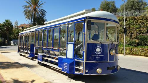 a blue trolley car parked on a street at Mara's Apartments Higuerón West - Mediterranean Style - Beach & Golf - Large Sunny Terrace in Fuengirola