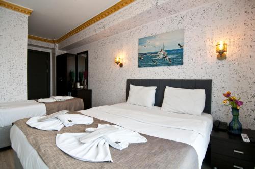 a hotel room with two beds with towels on them at Golden Horn Park Hotel in Istanbul