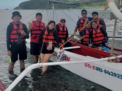 a group of people in a boat in the water at Jeremiah Homestay near Masasa Beach in Batangas City