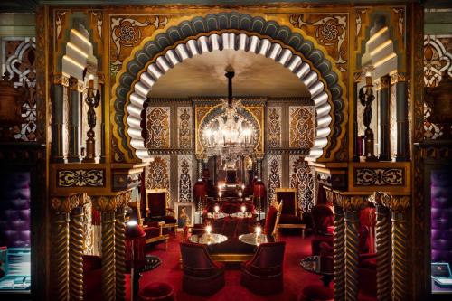 een grote kamer met een kroonluchter en stoelen bij Maison Souquet, Hotel & Spa in Parijs
