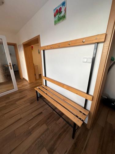 a wooden bench sitting in the middle of a room at Vila v Brdech s bazénem, infra saunou a vybavením in Malá Víska