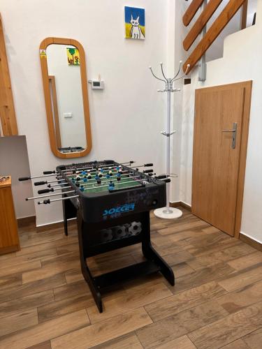 a foosball table in a room with a mirror at Vila v Brdech s bazénem, infra saunou a vybavením in Malá Víska