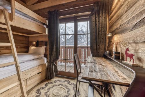 a bedroom with a bunk bed and a desk in a cabin at Chalet 3 étoiles pour 4 pers avec vue imprenable sur la vallée de Chamonix in Les Houches