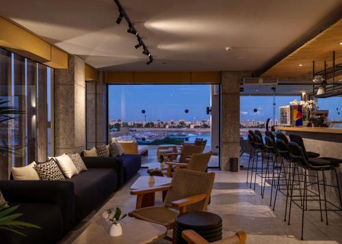 a living room with a couch and chairs and a bar at Creek Hotel and Residences El Gouna in Hurghada
