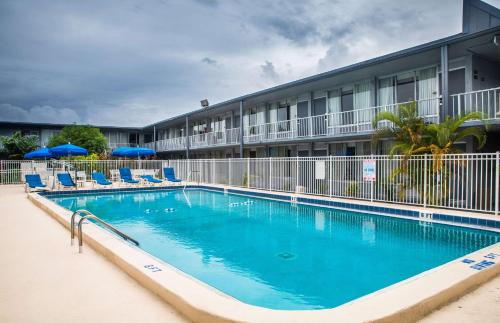 a large swimming pool in front of a hotel at Days Inn by Wyndham Stuart in Stuart