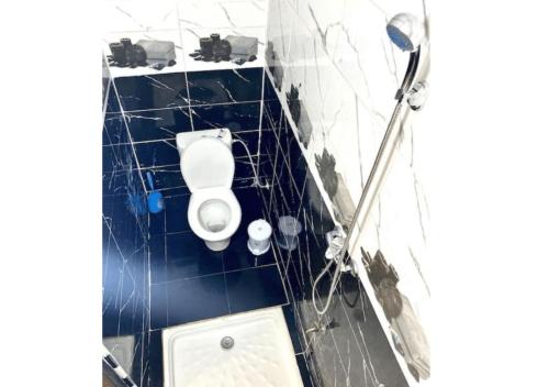 a bathroom with a white toilet in a room at Apartment in Safi near the beach the sea calm down in Safi