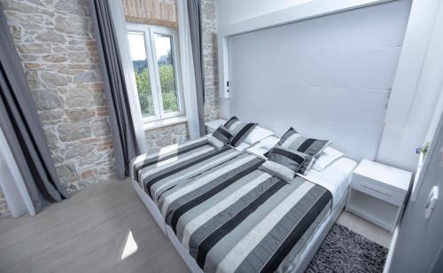 two beds in a room with a window at A Heritage Split in Split