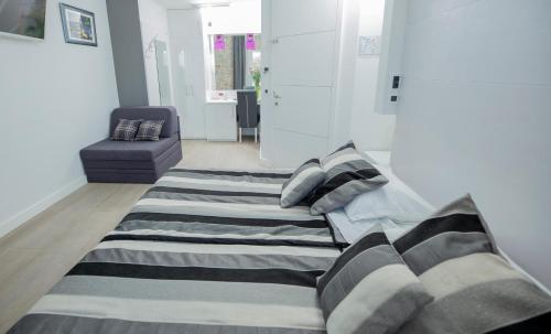 a bed in a room with a couch and a chair at A Heritage Split in Split