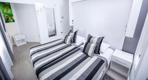 a bedroom with two beds with striped pillows at A Heritage Split in Split