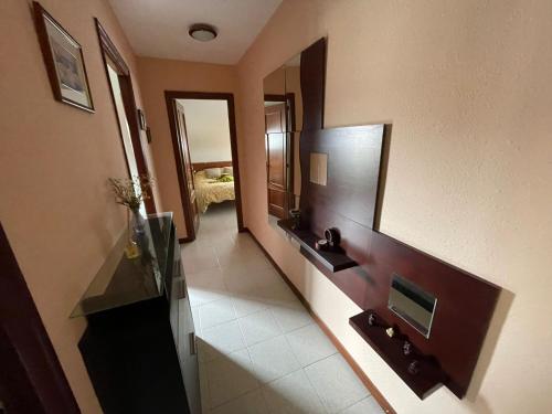 a hallway of a hotel room with a mirror at NOJALUZ in Noja