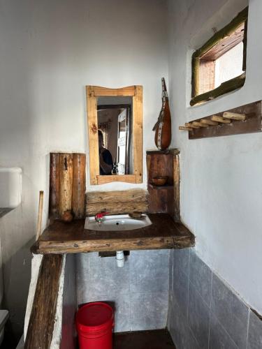 a bathroom with a wooden sink and a mirror at Uvi House & Restaurant 