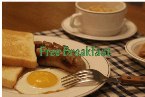 a plate of breakfast with egg and bread and a fork at Bexco Hostel B&B in Busan