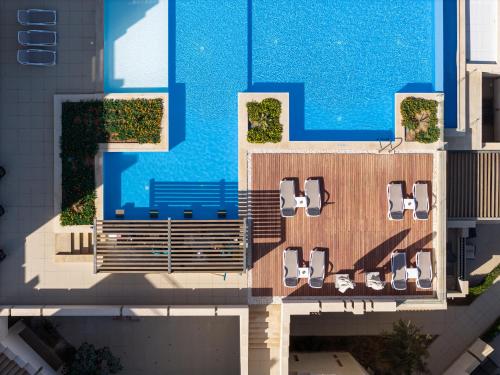 an overhead view of a swimming pool with chairs and a swimming pool at Creek Hotel and Residences El Gouna in Hurghada