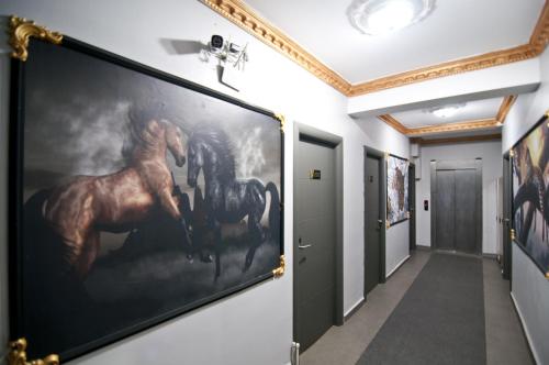 a hallway with a large painting of a horse on the wall at Golden Horn Park Hotel in Istanbul