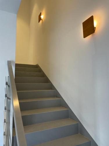 a staircase in a building with two lights on the wall at "be-together" Engabrunn in Engabrunn