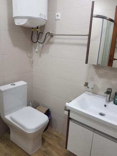 a bathroom with a white toilet and a sink at Euro Palace Gonio in Gonio