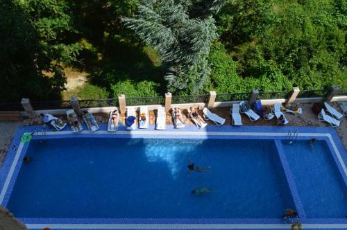 a group of people sitting around a swimming pool at Euro Palace Gonio in Gonio