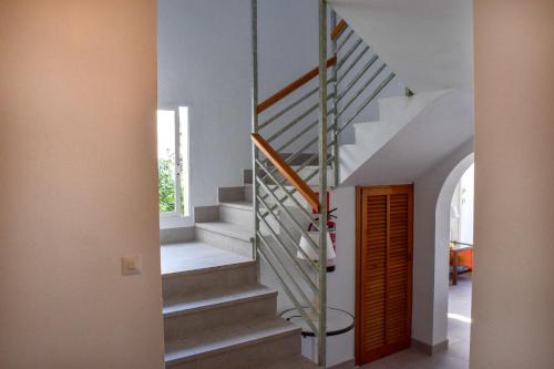 a staircase in a home with white walls at Villa Alexia - APARTMENT CORAL - Puerto Pollensa in Port de Pollensa