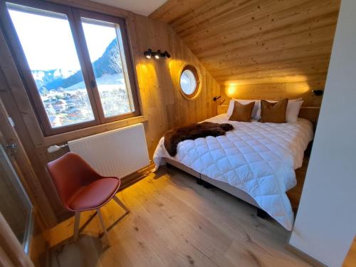 a bedroom with a bed with a cat laying on it at Chalet Yuki in Morzine