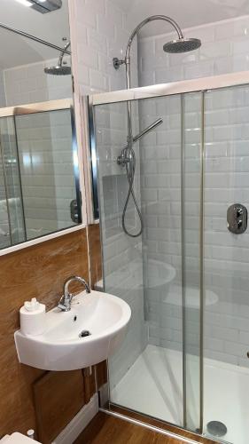 a bathroom with a sink and a shower at Glenisle Cottage in Lamlash
