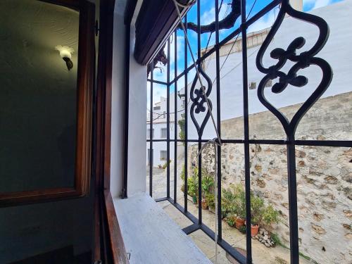 an iron gate in front of a door at La Posada Amena in Carcabuey