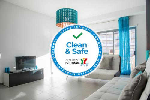 a sign for a clean and safe living room at Praia da Rocha Beach Retreat in Portimão