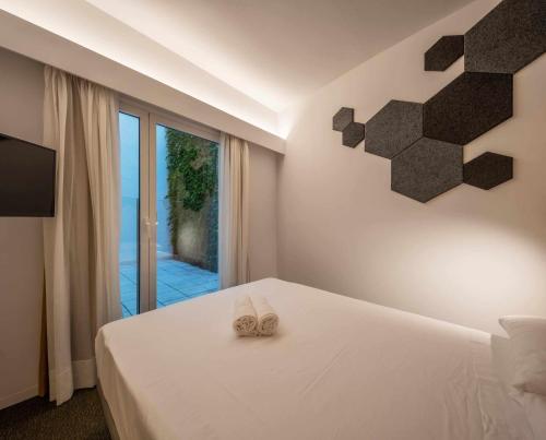 a bedroom with a bed with two slippers on it at Nature by Raidom in Alicante
