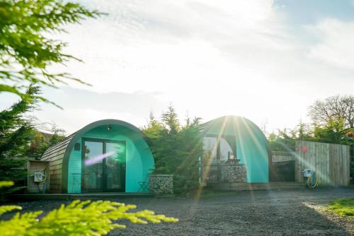 a green igloo house in a garden at Original Glamping Pod with Hot Tub in Frodsham