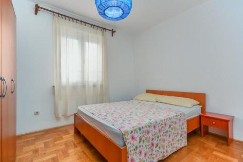 a bedroom with a bed and a window at Apartment Nena in Novigrad Istria