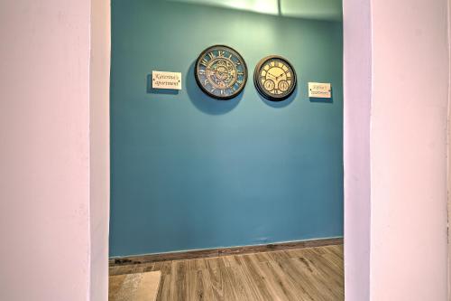 a blue wall with two plates on it at Katerina's Apartment in Nafplio