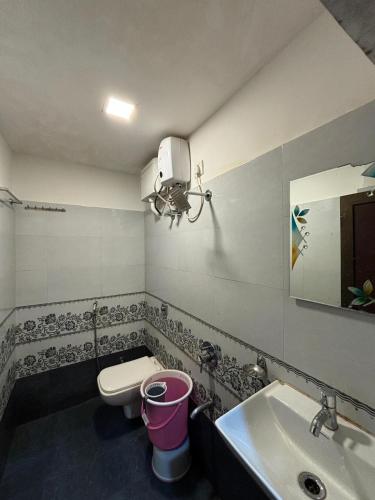a bathroom with a sink and a toilet and a mirror at Hotel Borivali Executive - Near Borivali Railway Station in Mumbai