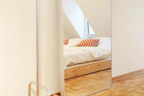 a bedroom with a bed and a mirror at reoh I Maisonette am See I Malerischer Ausblick I Beamer I Berlin in 30min in Strausberg