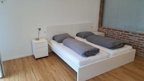 a bed with two pillows on it in a room at Kara Ben Nemsi in Ilmmünster