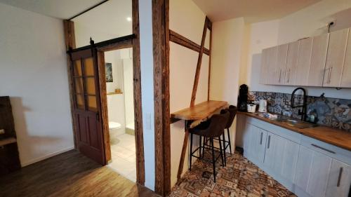a kitchen with a counter and a sink and a doorway at Hopfenalm in Ilmmünster
