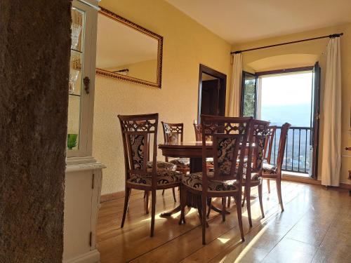 a dining room with a table and chairs and a balcony at Palacio Marqués Vega de Anzo - Villa de campo sXVII in Siero