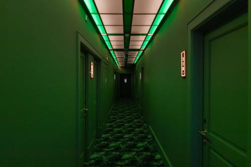 a hallway with green walls and a ceiling with green lights at Art Legacy Hotel Baixa-Chiado in Lisbon