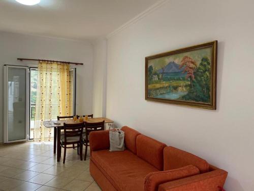 a living room with a couch and a table at Loukas Apartments in Karavostamo