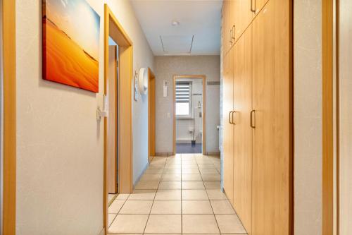 a corridor of a hallway with a painting on the wall at Münsterland Stadtlohn in Stadtlohn
