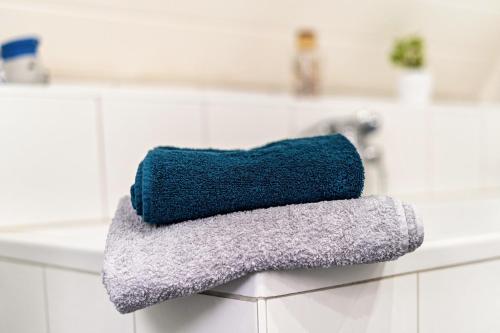 a blue towel sitting on top of a bathroom counter at Münsterland Stadtlohn in Stadtlohn