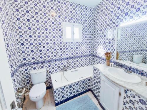 a blue and white bathroom with a toilet and a sink at Le Superbe - Sidi Bou Saïd in Dar Mimoun Bey