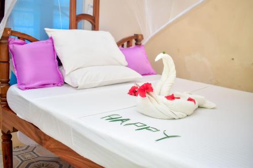 Кровать или кровати в номере Blue Earth Beach Bungalow