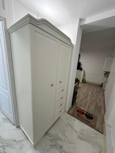 a white closet with a door in a room at Viking Apartment Grigo in Cluj-Napoca