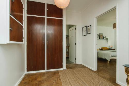 a room with a large wooden closet and a bed at Low Cost Subway Privado in Lisbon