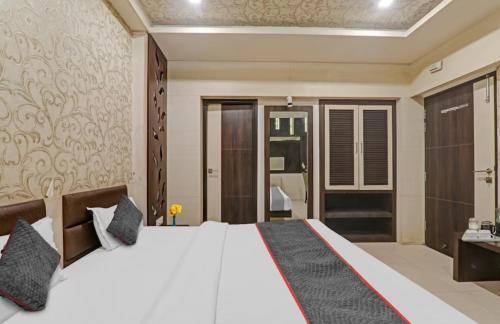 a bedroom with a large white bed in a room at Hotel Tirupati Galaxy in Kānpur